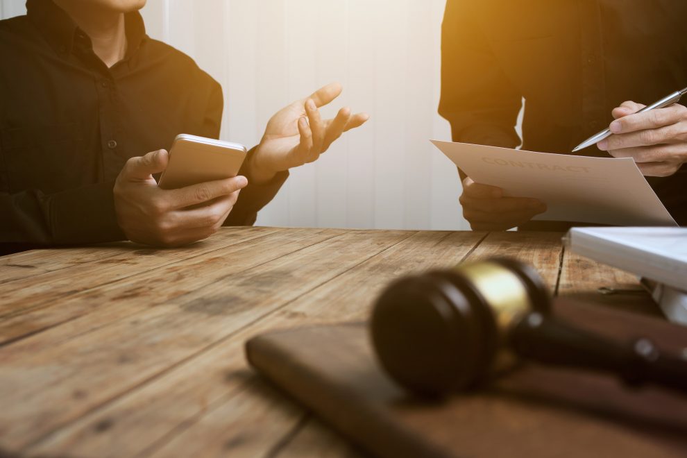 A team of lawyers and legal advisors working together. Discuss the details of the case of the accused.
