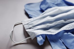 Protective medical face mask and latex gloves. Personal protective equipment shortage concept. Coronavirus, covid 19 prevention
